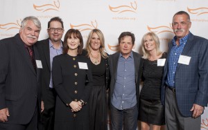 Board Members from the Danville d'Elegance (DDE) Foundation -- Tom Halloran, Brian Stephenson, Robin Halloran, Cadi Stephenson and co-founders Chris & Jim Edlund -- surround Michael J. Fox (center) after earning recognition as 'Top Fundraiser Nationwide' for Team Fox, the grassroots fundraising arm of the Michael J. Fox Foundation. DDE, celebrating its 10th anniversary in 2014, has raised more than $2mm for Parkinson's research and patient care over the past decade.