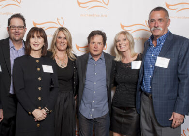 Board Members from the Danville d'Elegance (DDE) Foundation -- Tom Halloran, Brian Stephenson, Robin Halloran, Cadi Stephenson and co-founders Chris & Jim Edlund -- surround Michael J. Fox (center) after earning recognition as 'Top Fundraiser Nationwide' for Team Fox, the grassroots fundraising arm of the Michael J. Fox Foundation. DDE, celebrating its 10th anniversary in 2014, has raised more than $2mm for Parkinson's research and patient care over the past decade.