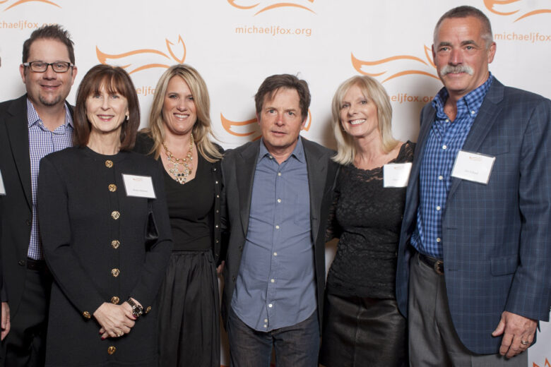 Board Members from the Danville d'Elegance (DDE) Foundation -- Tom Halloran, Brian Stephenson, Robin Halloran, Cadi Stephenson and co-founders Chris & Jim Edlund -- surround Michael J. Fox (center) after earning recognition as 'Top Fundraiser Nationwide' for Team Fox, the grassroots fundraising arm of the Michael J. Fox Foundation. DDE, celebrating its 10th anniversary in 2014, has raised more than $2mm for Parkinson's research and patient care over the past decade.